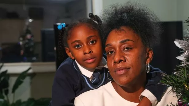 ​Private renter Janiece , who has received an eviction notice, with her daughter